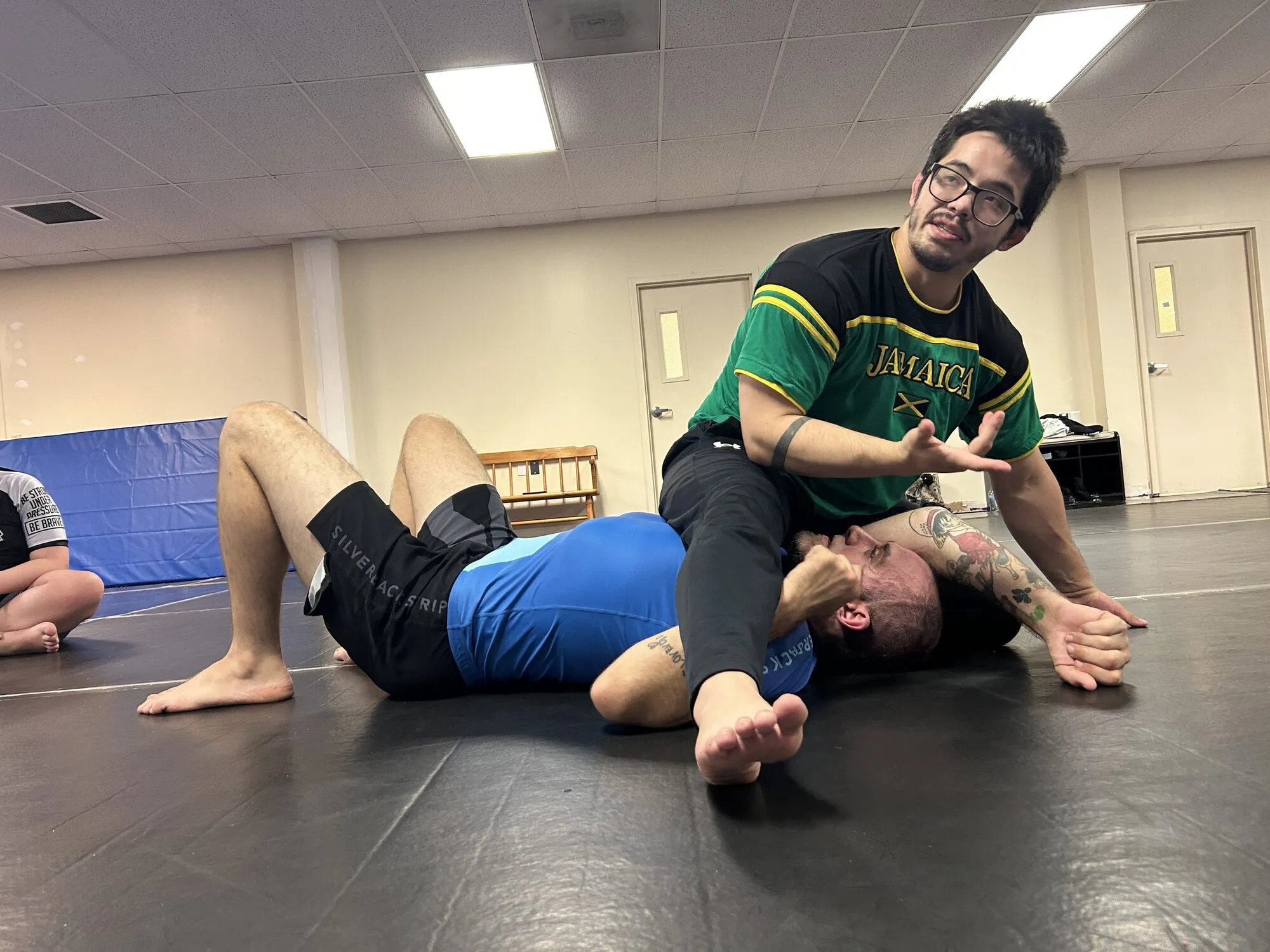 Two people rolling on the mats at Mat Lab