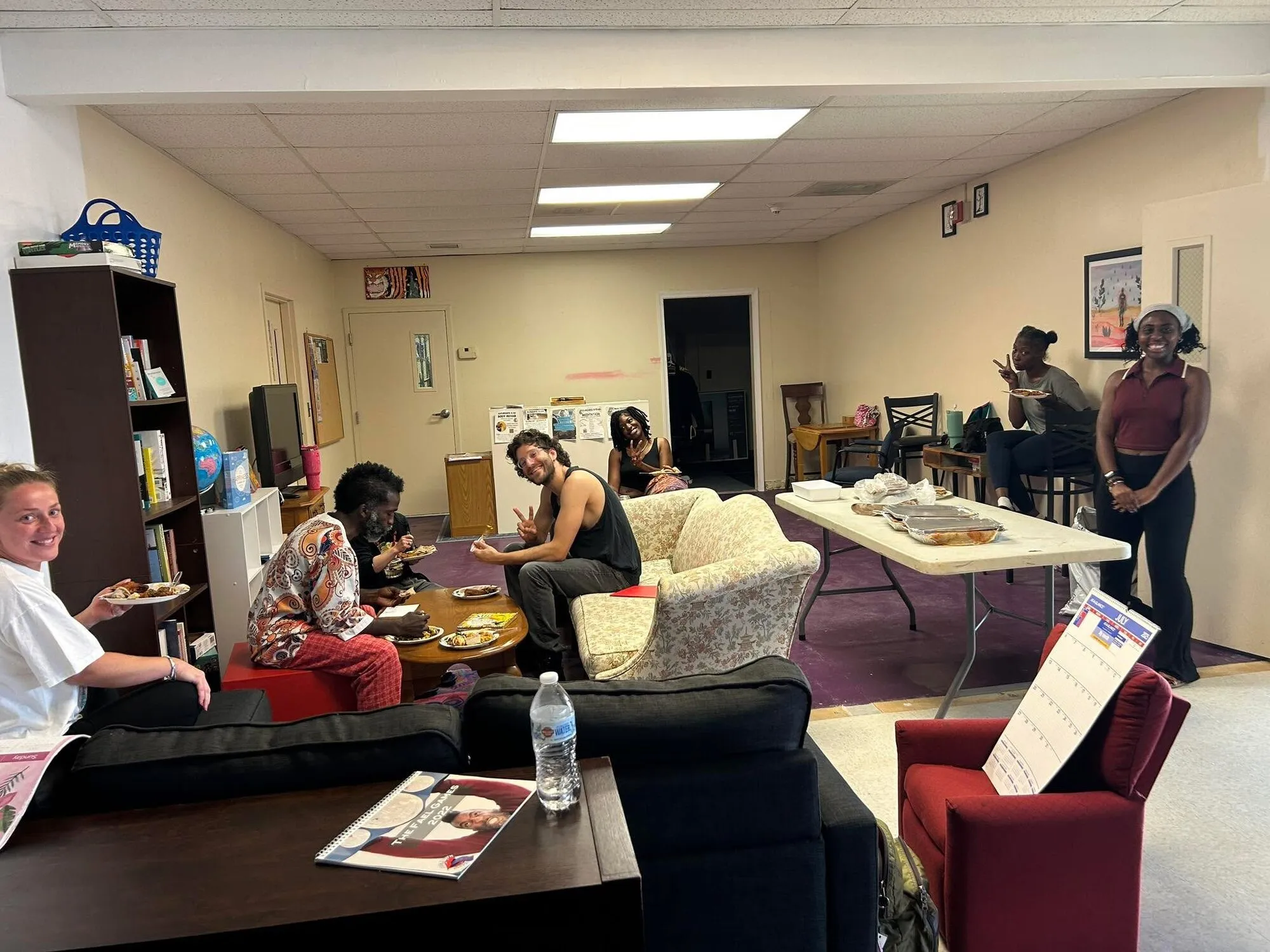 The community lounge with couches and shelves