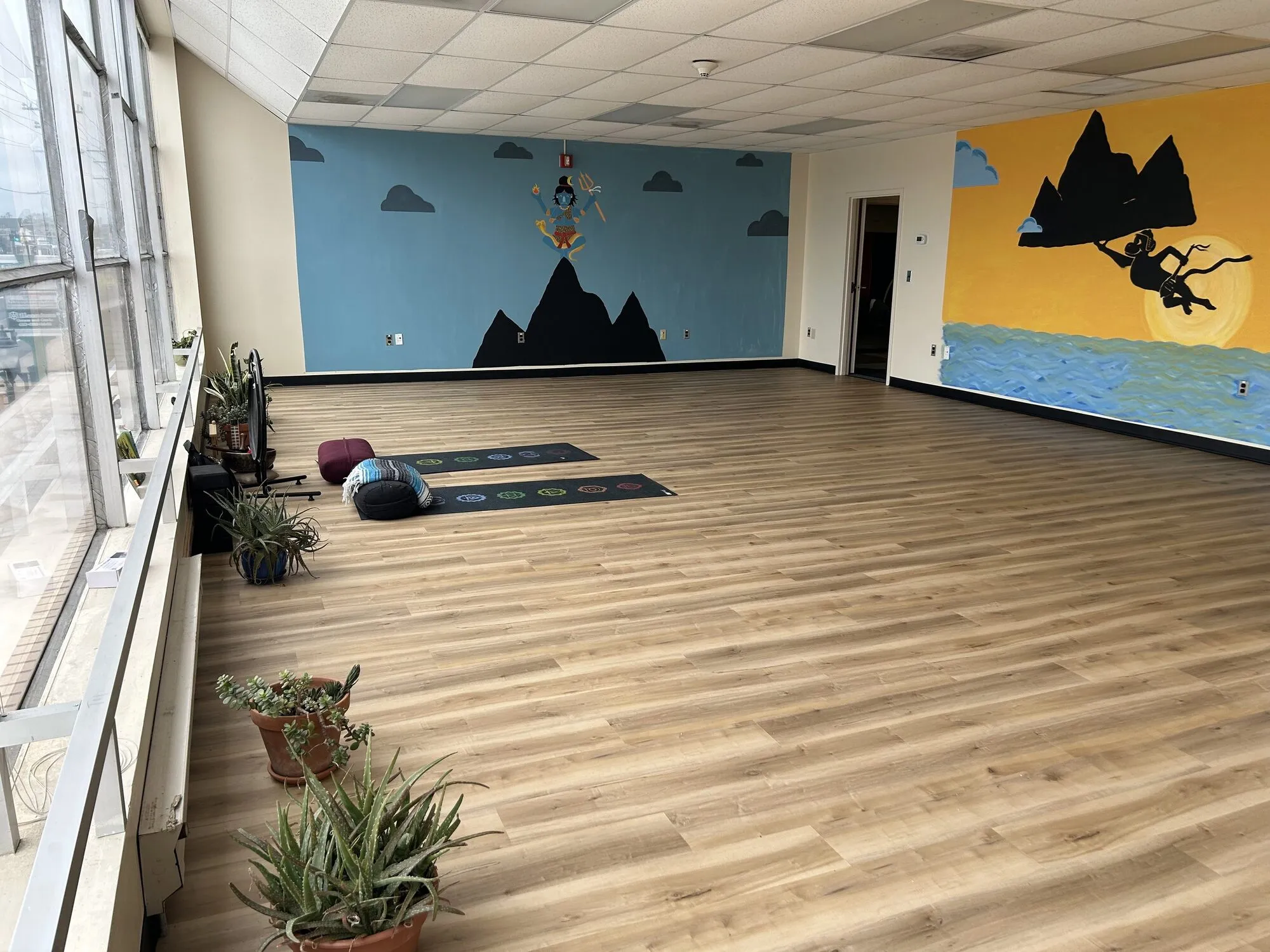 A hand-painted mountain and sky mural on the studio wall